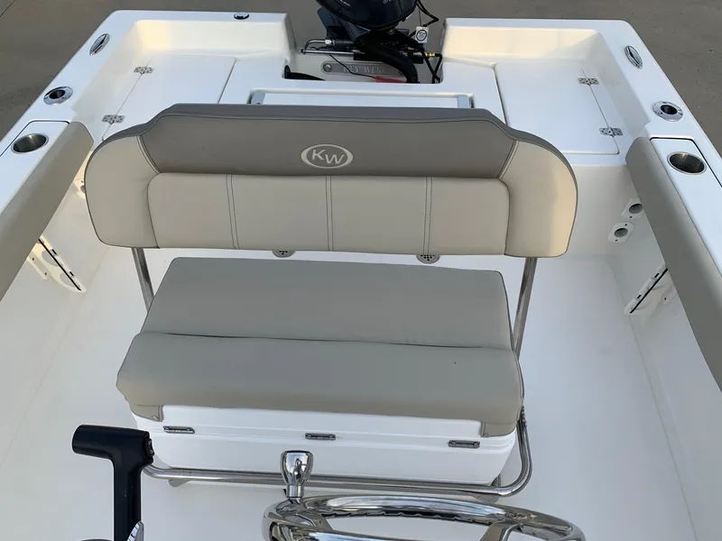 Slide: The Image of 2024 Key West 179 FS boat interior with cushioned seating and steering wheel. - 7