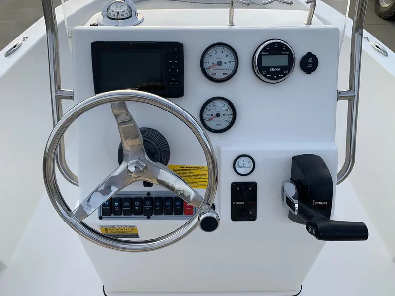 Slide: The Image of 2024 Key West 179 FS boat console with steering wheel, gauges, and controls. - 9