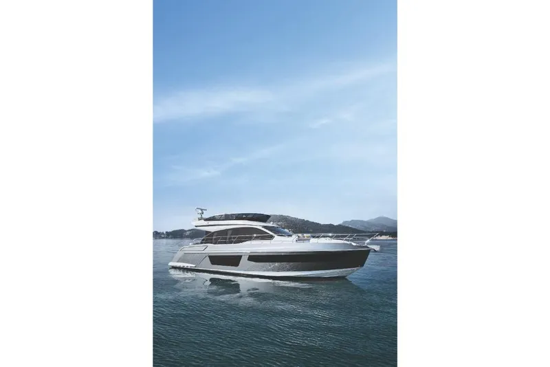 Slide: The Image of 2023 Azimut 53 yacht cruising on calm waters under a clear blue sky. - 13