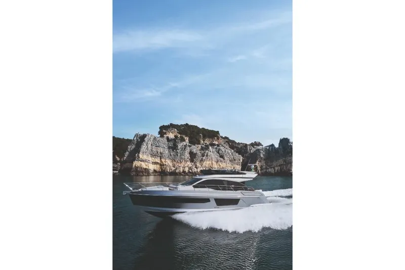 Slide: The Image of 2023 Azimut 53 yacht cruising near rocky cliffs. - 35
