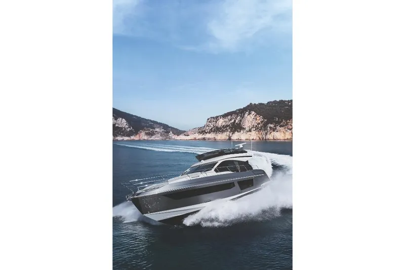 Slide: The Image of 2023 Azimut 53 yacht cruising on open water near rocky coastline. - 36