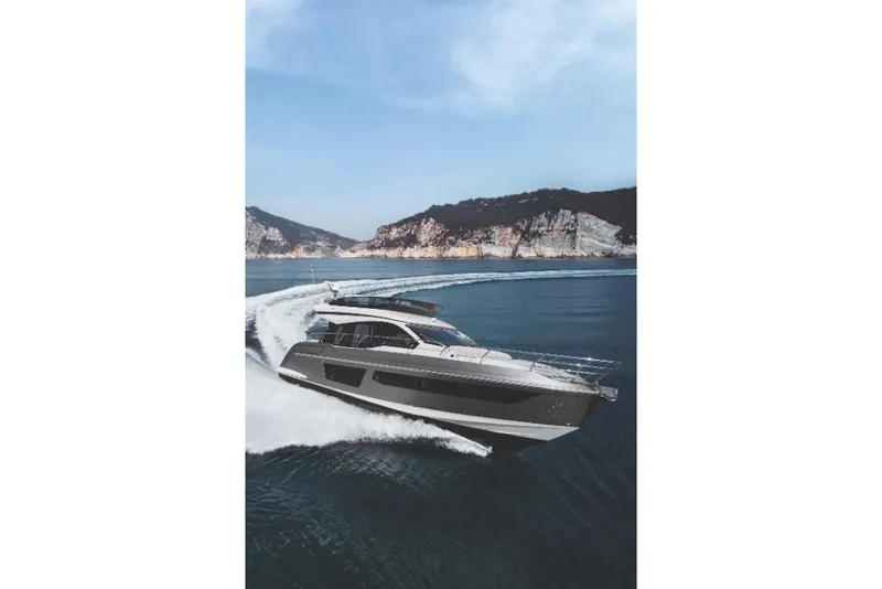 Slide: The Image of 2023 Azimut 53 yacht cruising on open water with scenic mountain backdrop. - 37
