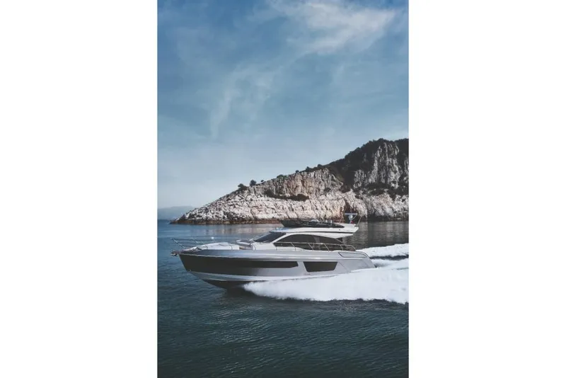 Slide: The Image of 2023 Azimut 53 yacht cruising near rocky coastline. - 40