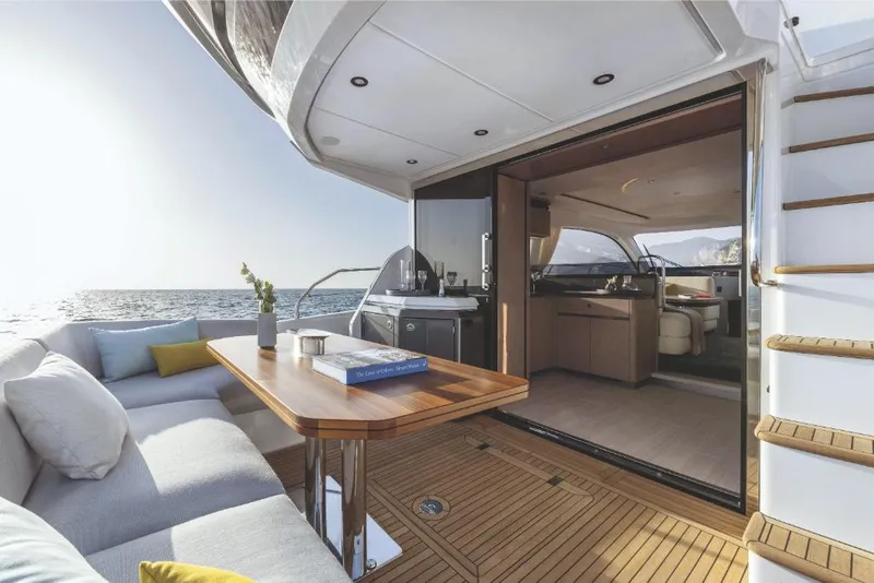 Slide: The Image of Luxurious 2023 Azimut 53 yacht interior with ocean view, wooden deck, and modern seating area. - 9
