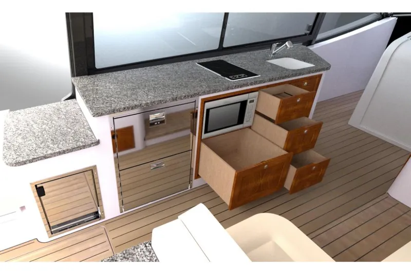 Slide: The Image of Modern MJM 4 yacht kitchen with granite countertops, microwave, and wooden drawers, 2023 model. - 3