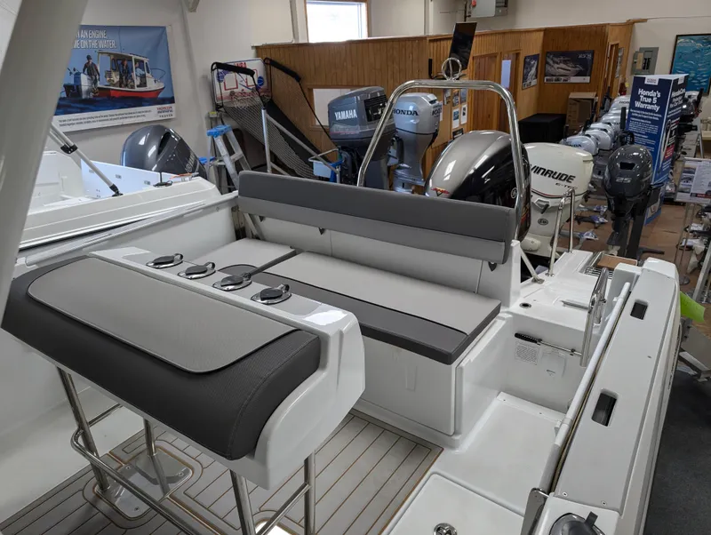 Slide: The Image of 2023 Jeanneau Leader 6.5 S3 CC boat interior with seating and outboard motors. - 4