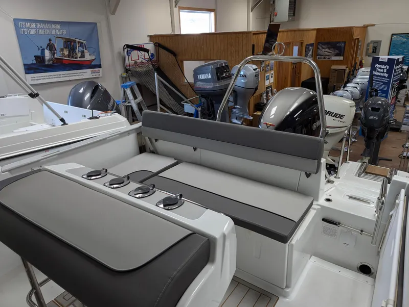 Slide: The Image of 2022 Jeanneau Leader 6.5 S3 CC boat interior with seating and outboard motors. - 4