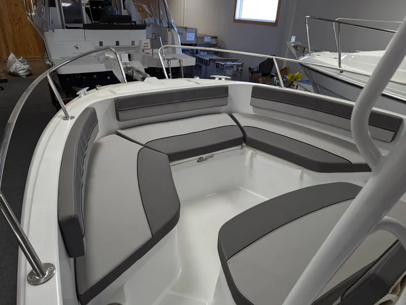 Slide: The Image of 2022 Jeanneau Leader 6.5 S3 CC boat interior with cushioned seating. - 6