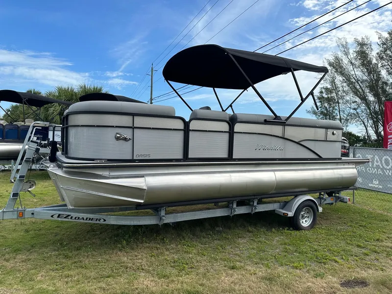 Slide: The Image of 2022 Manitou Oasis 21 RF VP pontoon boat on trailer. - 0