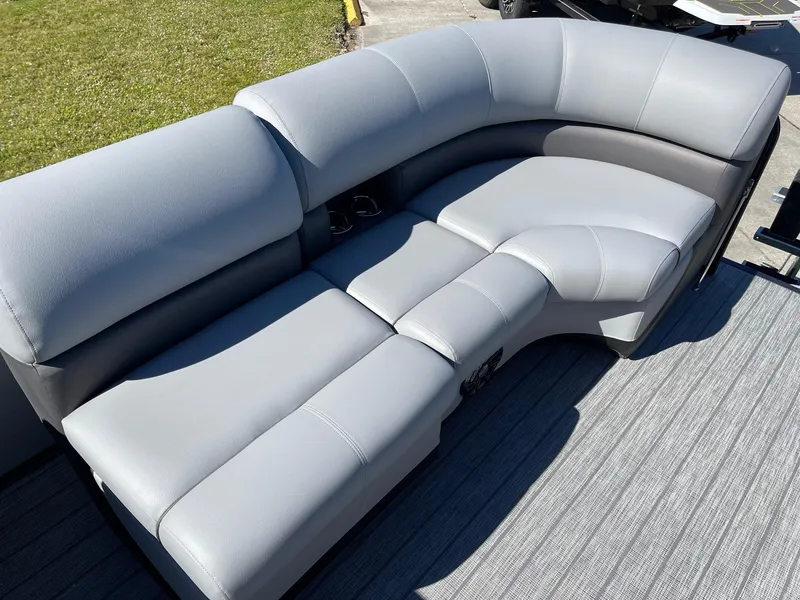 Slide: The Image of 2022 Manitou Oasis 21 RF VP boat with gray cushioned seating. - 11