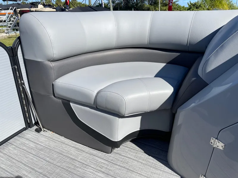 Slide: The Image of 2022 Manitou Oasis 21 RF VP pontoon boat with gray cushioned seating. - 12