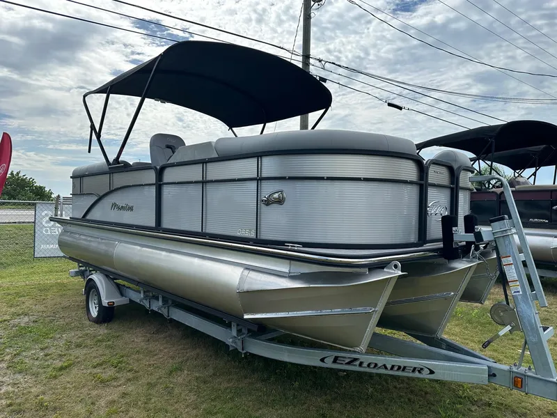 Slide: The Image of 2022 Manitou Oasis 21 RF VP pontoon boat on EZ Loader trailer. - 2