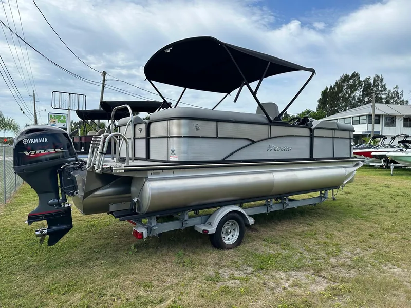 Slide: The Image of 2022 Manitou Oasis 21 RF VP pontoon boat with Yamaha outboard motor. - 4