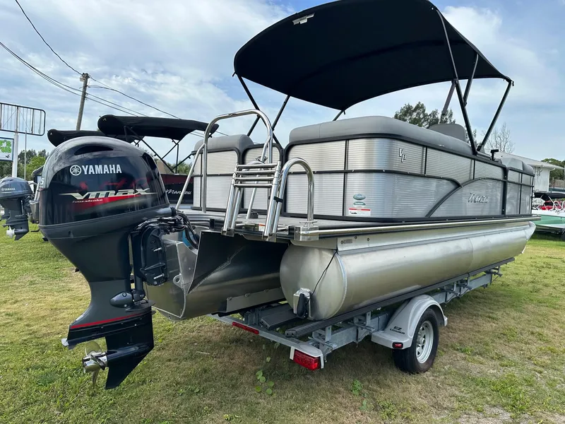 Slide: The Image of 2022 Manitou Oasis 21 RF VP pontoon boat with Yamaha outboard motor. - 5