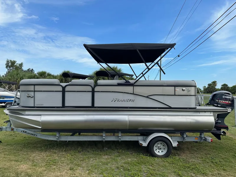 Slide: The Image of 2022 Manitou Oasis 21 RF VP pontoon boat on trailer with canopy. - 8