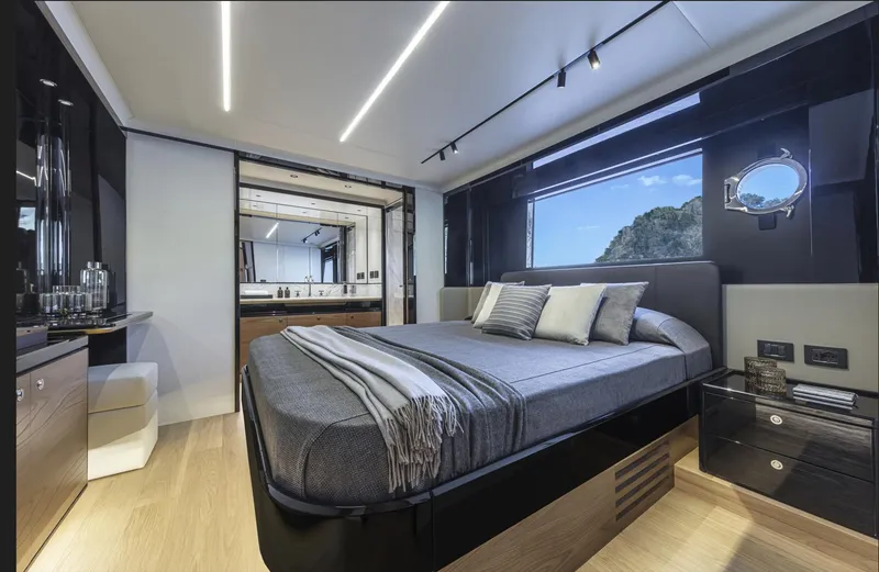 Slide: The Image of Luxurious bedroom interior of 2025 Absolute Navetta 64 yacht with modern design and scenic window view. - 16