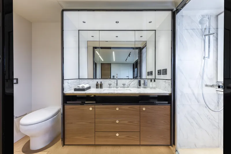 Slide: The Image of Luxurious bathroom on 2025 Absolute Navetta 64 yacht with modern fixtures and elegant design. - 18