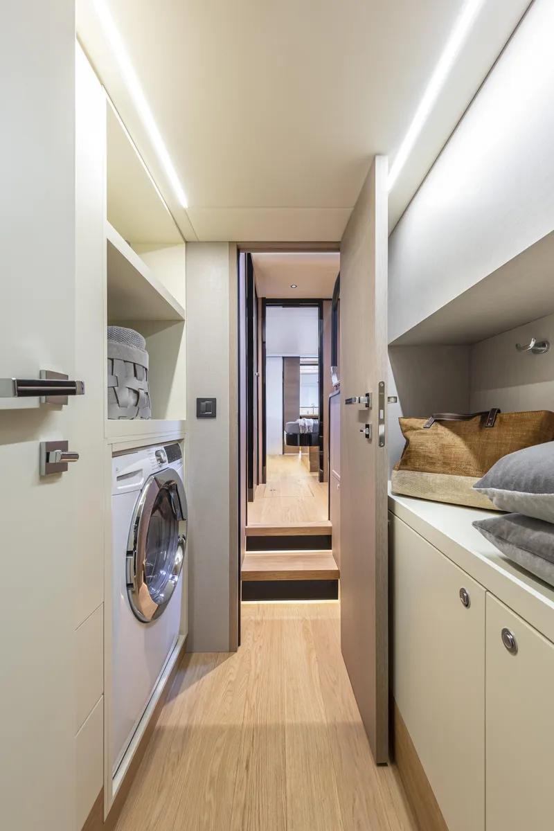 Slide: The Image of 2025 Absolute Navetta 64 yacht interior with laundry area and storage. - 19