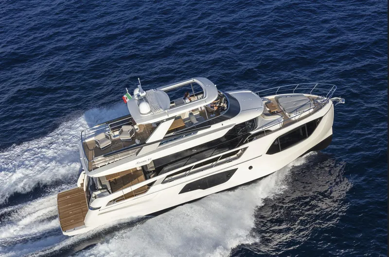 Slide: The Image of 2025 Absolute Navetta 64 yacht cruising on open sea. - 2