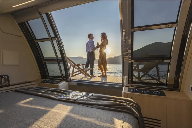 Slide: The Image of Couple enjoying sunset on Absolute Navetta 64 yacht, 2025 model, with luxurious interior view. - 6