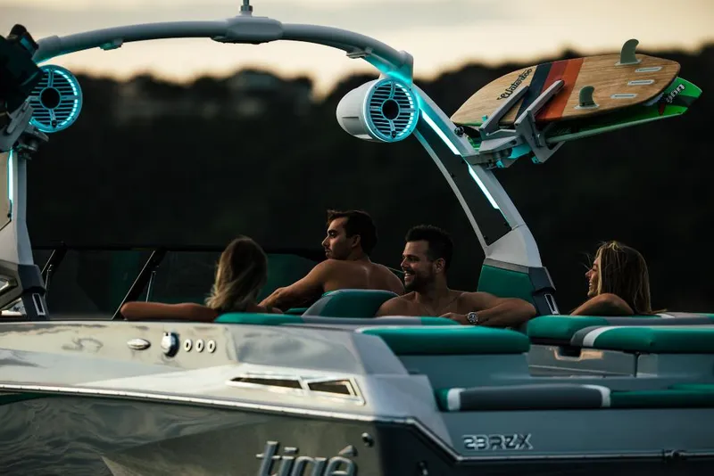 Slide: The Image of 2023 Tigé 24RZX boat with passengers enjoying a sunset cruise. - 26
