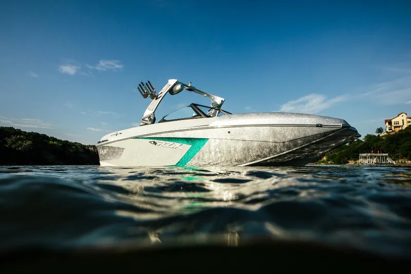 Slide: The Image of 2023 Tigé 24RZX boat on water, side view with clear blue sky. - 3