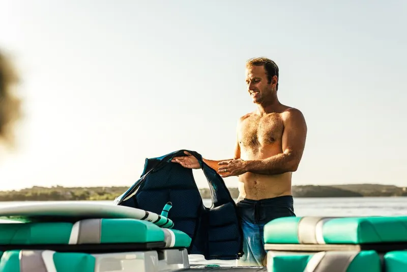 Slide: The Image of Man on 2023 Tigé 24RZX boat holding a life jacket. - 39