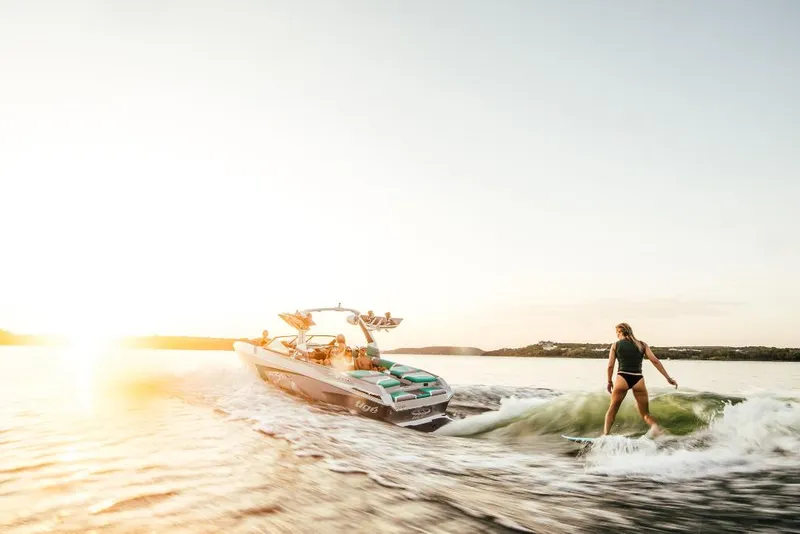 Slide: The Image of 2023 Tigé 24RZX boat with a person wakesurfing at sunset. - 40