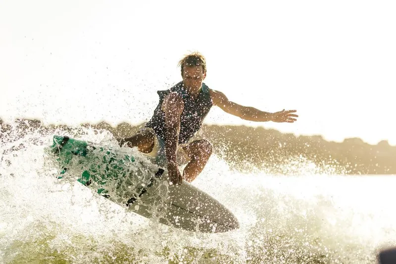 Slide: The Image of Wakeboarder performing trick behind 2023 Tigé 24RZX boat. - 43