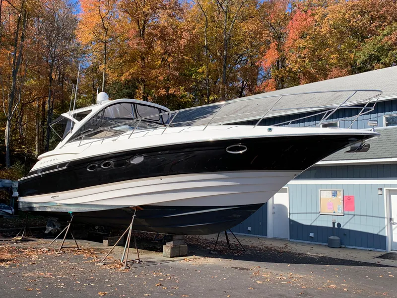 Slide: The Image of 2009 Regal 4460 yacht on dry dock with autumn foliage background. - 1
