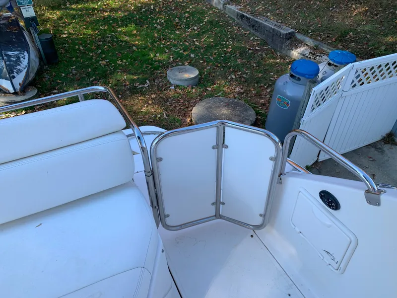 Slide: The Image of 2009 Regal 4460 boat with open gate and white seating. - 15