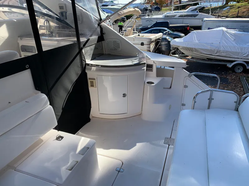 Slide: The Image of 2009 Regal 4460 yacht interior with white seating and storage compartments. - 16