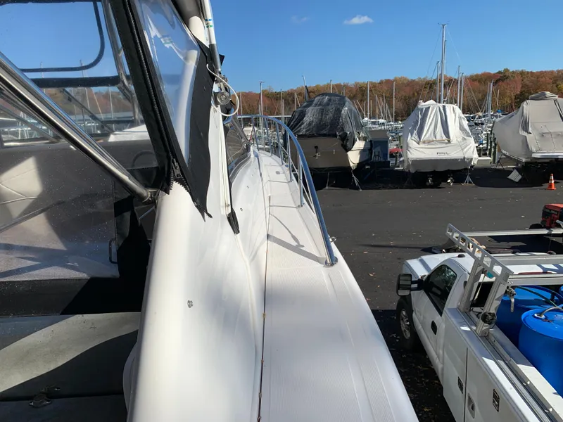 Slide: The Image of 2009 Regal 4460 yacht docked in a marina with other boats. - 17