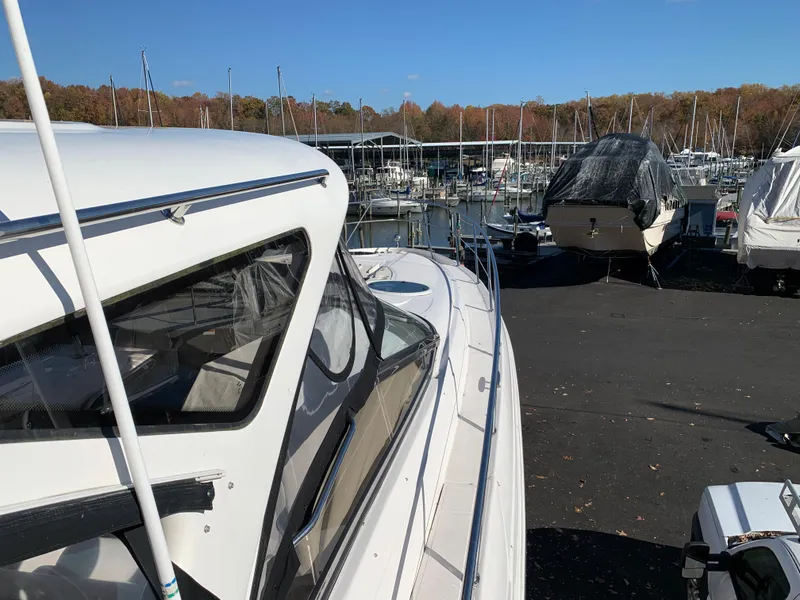 Slide: The Image of 2009 Regal 4460 yacht docked at a marina with other boats. - 19