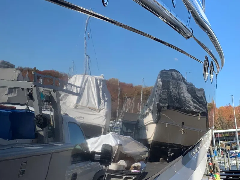 Slide: The Image of Reflection on the side of a 2009 Regal 4460 yacht in a marina. - 29