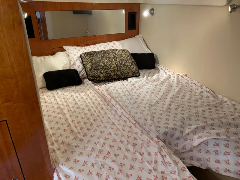 Slide: The Image of Luxurious 2009 Regal 4460 yacht bedroom with cozy bedding and elegant decor. - 41