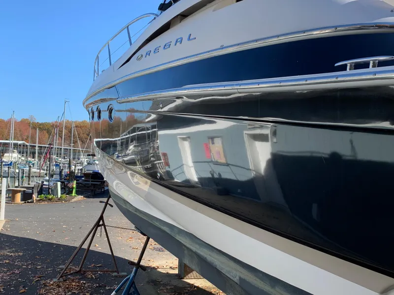 Slide: The Image of 2009 Regal 4460 yacht docked at a marina. - 5
