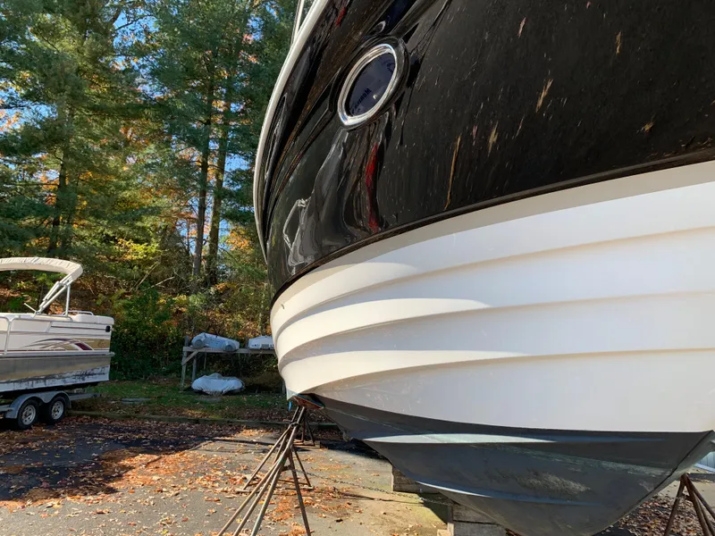 Slide: The Image of 2009 Regal 4460 boat on stands in a wooded area. - 8