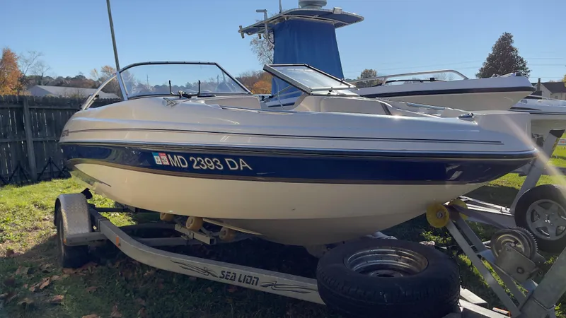 Slide: The Image of 2003 Glastron GX 180 Ski & Fish boat on a trailer in a yard. - 10