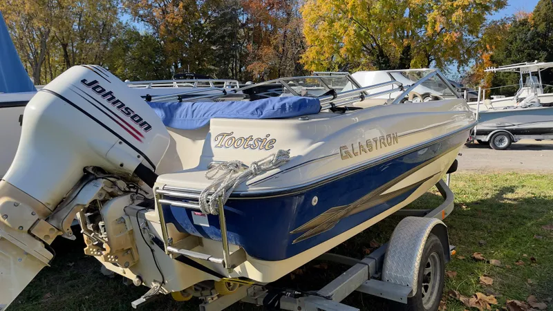 Slide: The Image of 2003 Glastron GX 180 Ski & Fish boat on trailer with Johnson outboard motor. - 12