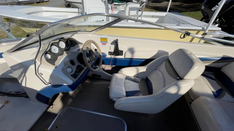 Slide: The Image of 2003 Glastron GX 180 Ski & Fish boat interior with steering wheel and seating. - 16