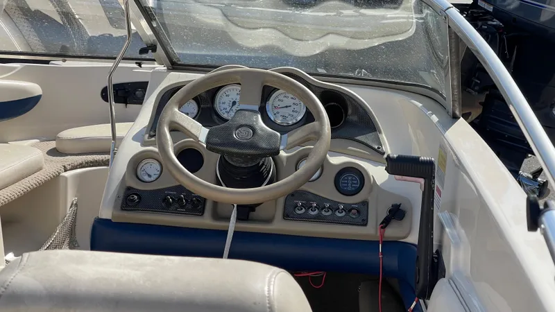 Slide: The Image of 2003 Glastron GX 180 Ski & Fish boat dashboard with steering wheel and gauges. - 17
