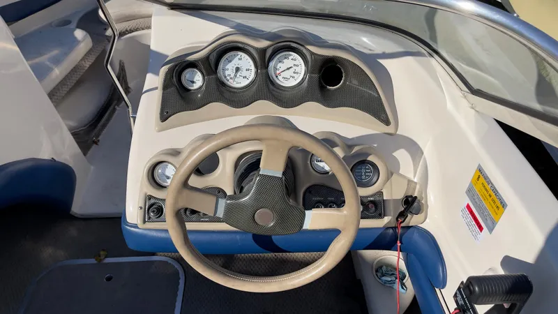 Slide: The Image of 2003 Glastron GX 180 Ski & Fish boat dashboard with steering wheel and gauges. - 18