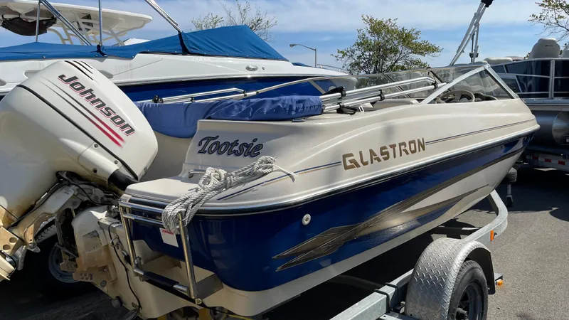 Slide: The Image of 2003 Glastron GX 180 Ski & Fish boat on trailer with Johnson outboard motor. - 2