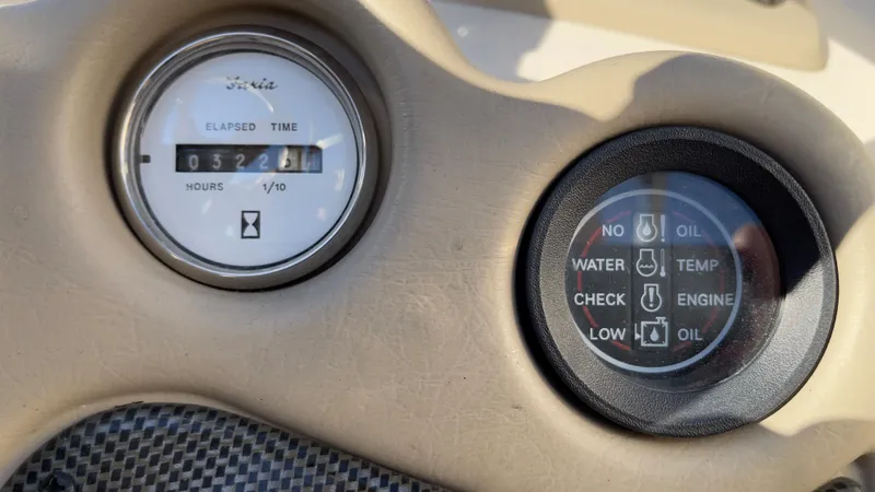 Slide: The Image of 2003 Glastron GX 180 Ski & Fish boat dashboard with hour meter and indicator lights. - 24