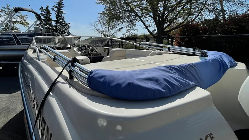 Slide: The Image of 2003 Glastron GX 180 Ski & Fish boat, rear view, docked, with blue cover. - 28