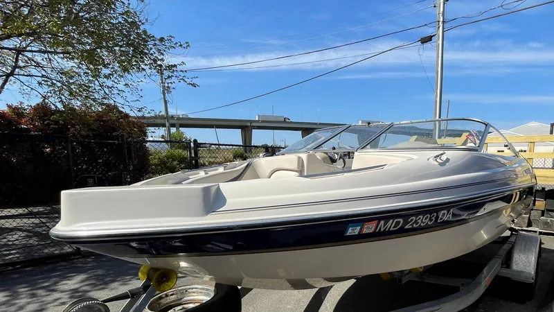 Slide: The Image of 2003 Glastron GX 180 Ski & Fish boat on trailer under clear blue sky. - 3