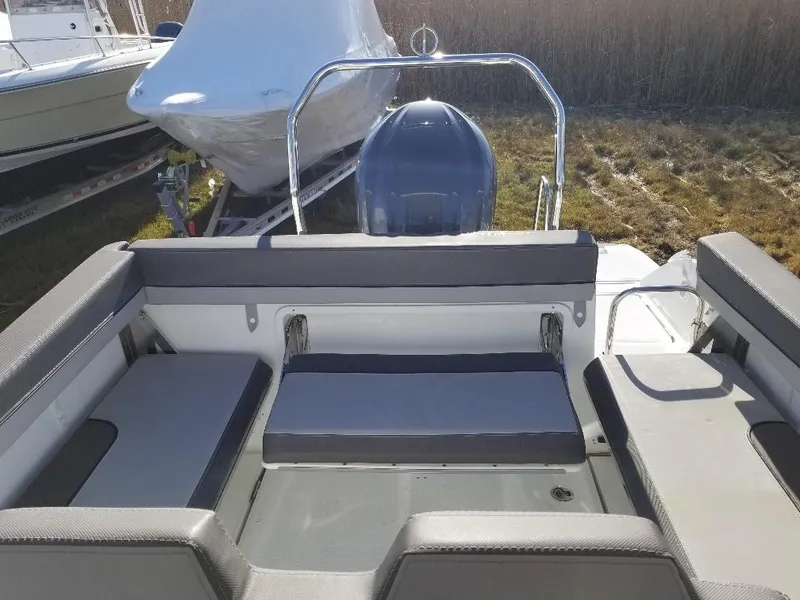 Slide: The Image of 2022 Jeanneau Leader 7.5 WA S3 boat interior with seating and outboard motor. - 12