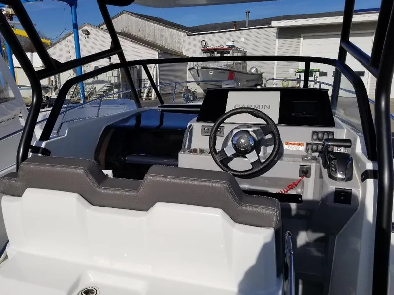 Slide: The Image of Interior view of 2022 Jeanneau Leader 7.5 WA S3 boat cockpit with steering wheel and controls. - 14