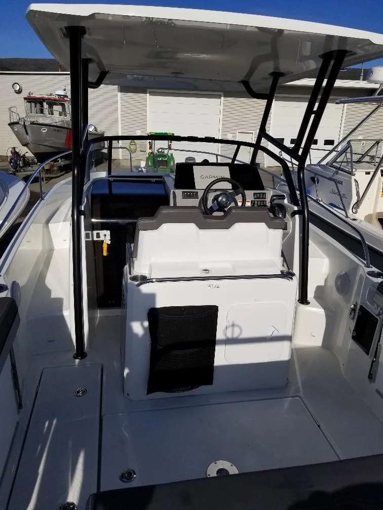 Slide: The Image of 2022 Jeanneau Leader 7.5 WA S3 boat interior with steering console and seating. - 15